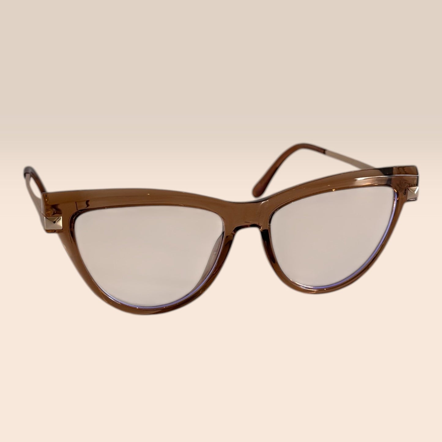 Cat-eye sunglasses with brown frame and clear lenses on a beige background